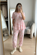 Woman wearing pink bow print peplum night suit with free size pants, soft cotton comfortable nightwear set.
