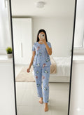Woman wearing sky blue peplum nightwear set at home
