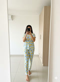Woman wearing lemon print peplum nightwear set at home
