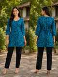 A woman modeling a teal blue and black leopard-print tunic top with three-quarter sleeves, shown in front and back views against an outdoor garden backdrop.