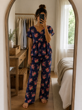 Woman wearing a premium navy blue ribbed knitted cotton peplum night suit with floral print, V-neck top, and matching straight-fit lounge pants by Irah Vastra.