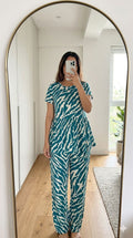 Woman wearing teal zebra print peplum night suit with relaxed fit pants, stylish and comfortable lounge wear set.